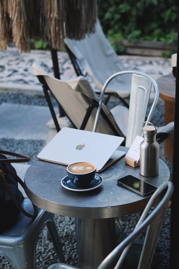 services-03 Outdoor workspace setup with laptop and coffee, offering a relaxing work environment.